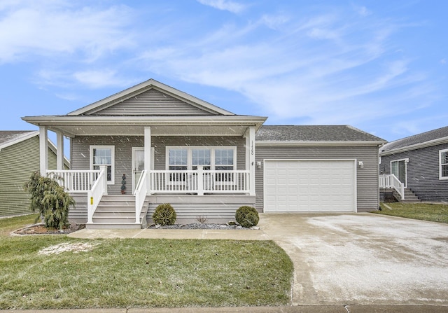 view of front of property featuring a front yard, a porch, and a garage