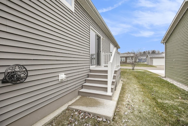 view of side of home with a lawn