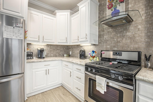 kitchen with crown molding, wall chimney exhaust hood, light stone countertops, appliances with stainless steel finishes, and white cabinetry