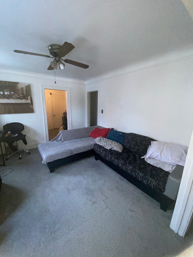 living room with carpet, ceiling fan, ornamental molding, and a textured ceiling