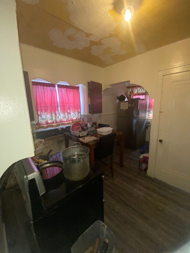 dining space with dark wood-type flooring and sink