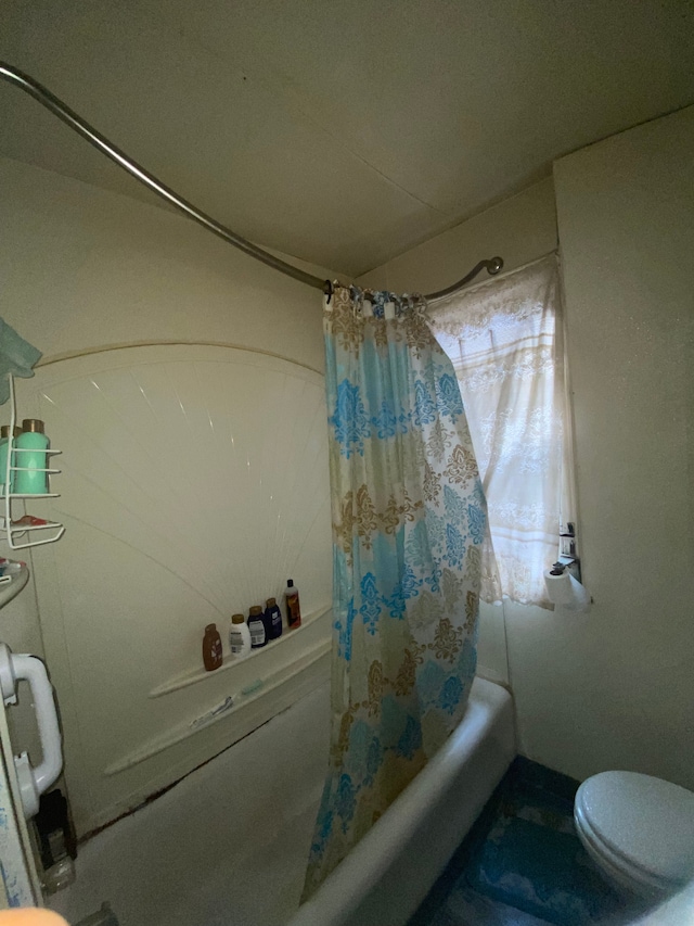 bathroom with shower / bath combination with curtain and toilet