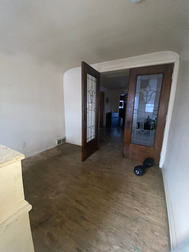 corridor with dark hardwood / wood-style floors