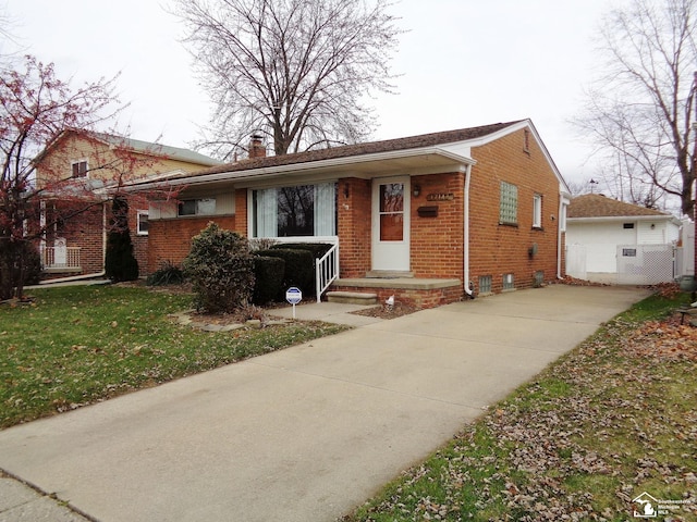 view of front of home with a garage, an outdoor structure, and a front lawn