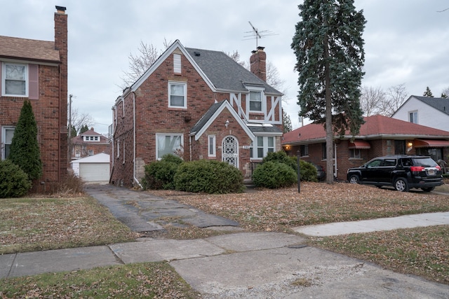 view of front facade featuring a garage and an outdoor structure