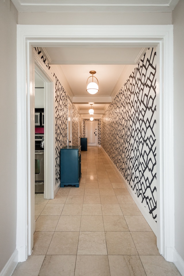 corridor with crown molding and light tile patterned flooring