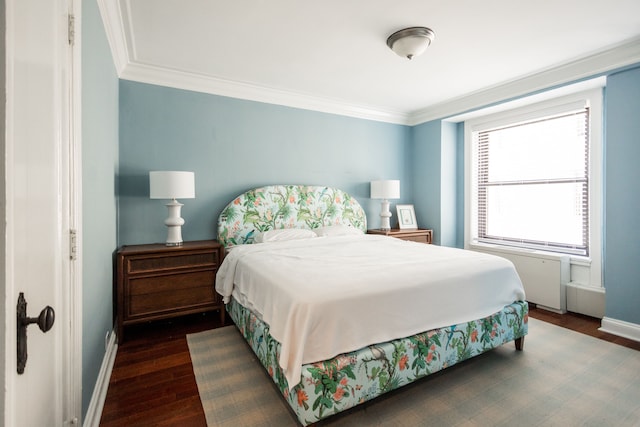 bedroom with crown molding and dark wood-type flooring