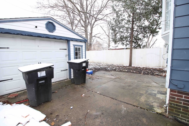 view of patio / terrace with an outbuilding and a garage