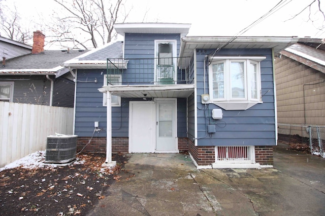 view of front of home with a balcony and cooling unit