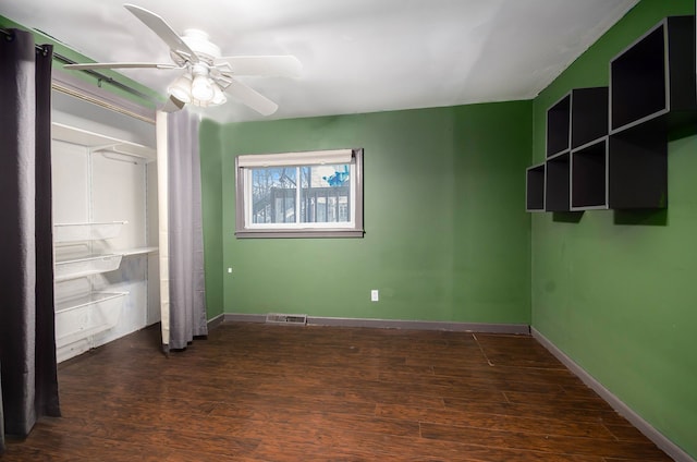 unfurnished bedroom with ceiling fan and dark hardwood / wood-style floors