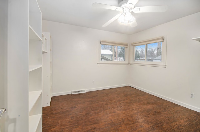 unfurnished room with dark hardwood / wood-style floors and ceiling fan