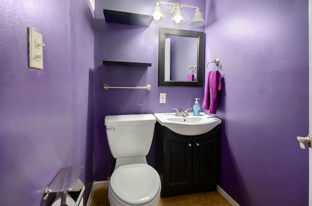 bathroom featuring vanity and toilet