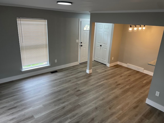 interior space with hardwood / wood-style floors and ornamental molding