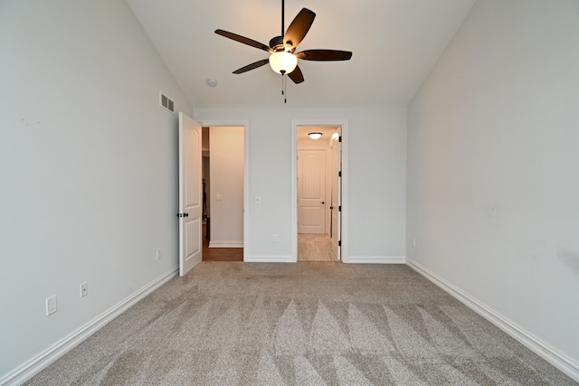 unfurnished bedroom featuring ceiling fan, light colored carpet, and vaulted ceiling