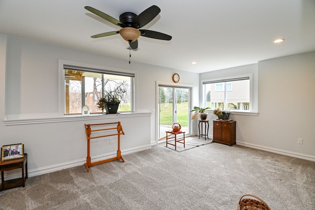 sitting room with carpet and ceiling fan