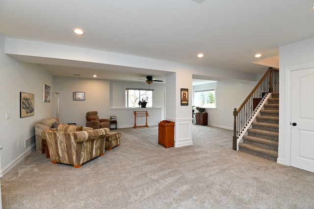 carpeted living room featuring ceiling fan