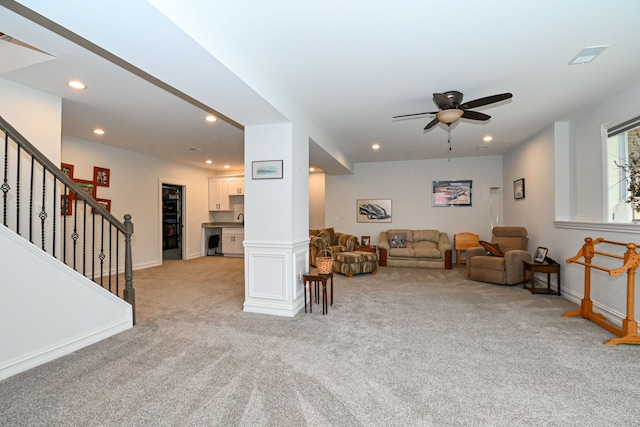 carpeted living room featuring ceiling fan