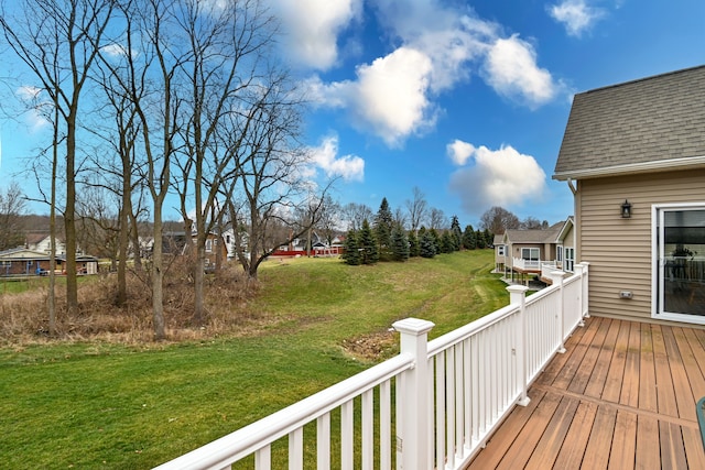 wooden deck featuring a lawn