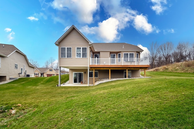 back of property featuring a wooden deck, a patio area, and a lawn