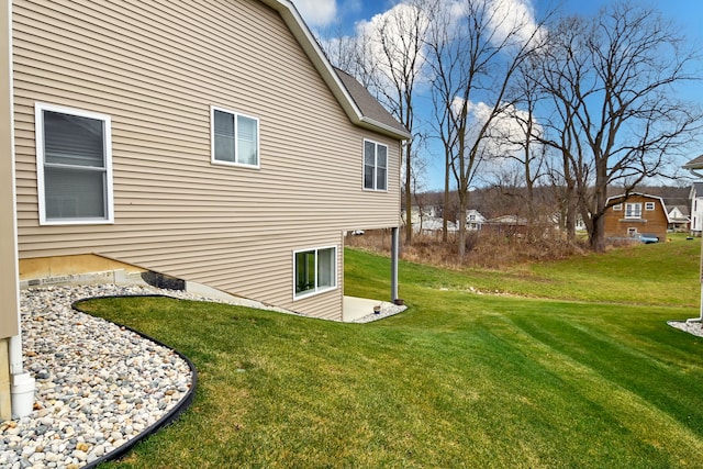 view of side of home with a yard