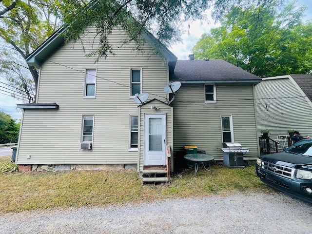 back of house featuring cooling unit