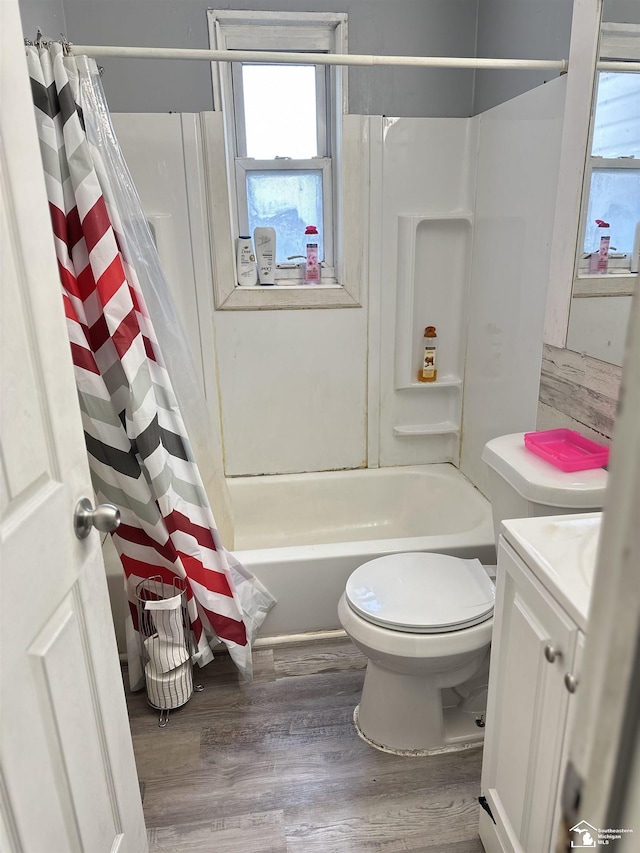 full bathroom featuring wood-type flooring, vanity, toilet, and shower / bath combination with curtain