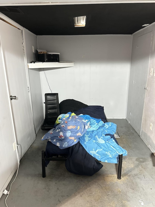 bedroom featuring concrete floors