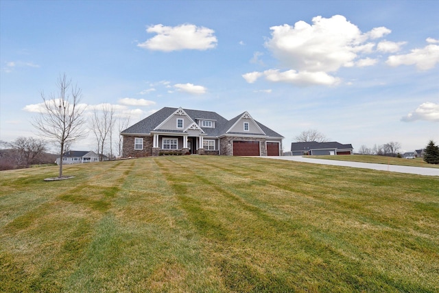 view of front of property featuring a front yard and a garage