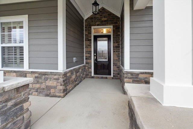 view of exterior entry with covered porch