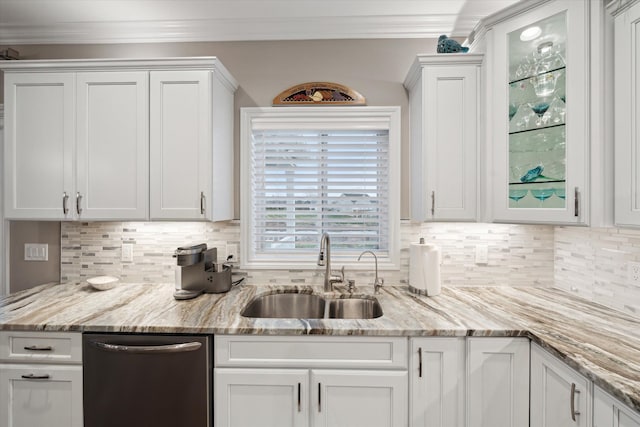 kitchen featuring backsplash, stainless steel dishwasher, white cabinetry, and sink