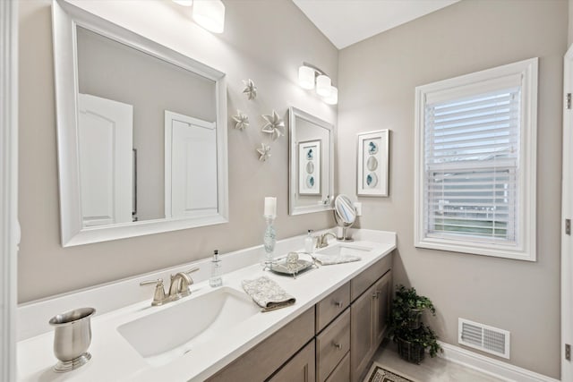 bathroom with vanity and a wealth of natural light