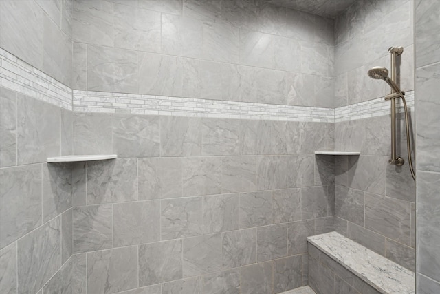 bathroom with a tile shower