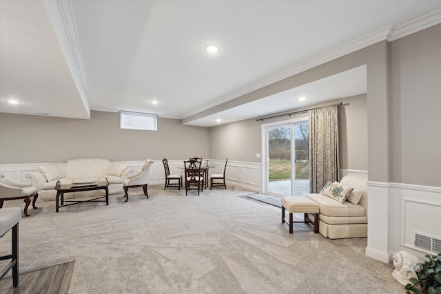 living area with light colored carpet and ornamental molding