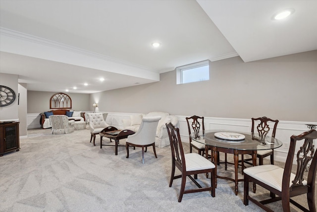 carpeted dining area featuring ornamental molding