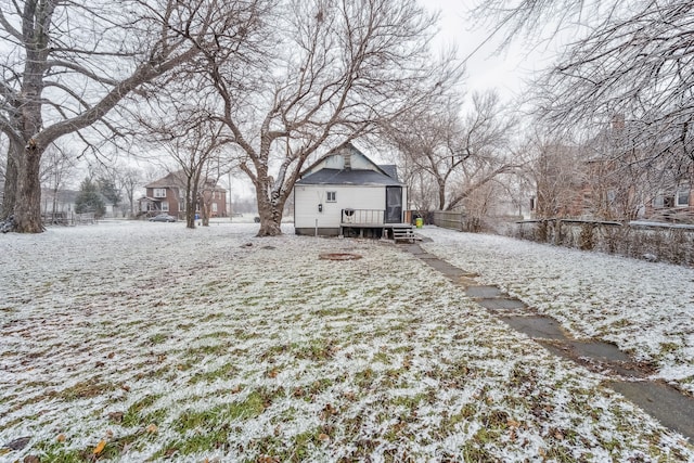 snowy yard featuring a wooden deck