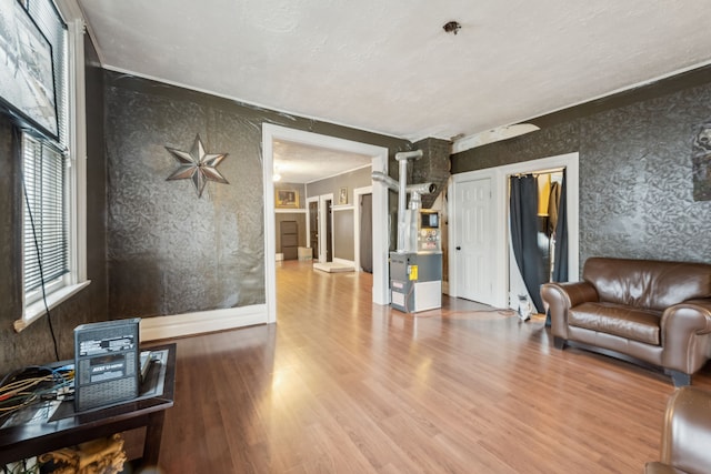 2619 Wabash St, Detroit, MI 48216 - living area featuring wood finished floors, a textured ceiling, and wallpapered walls