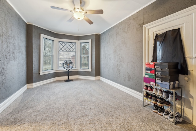 unfurnished room with carpet flooring, ceiling fan, and ornamental molding