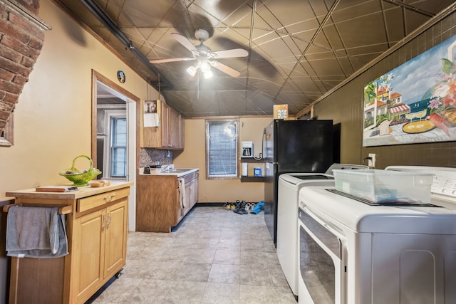 kitchen with washer and dryer, ceiling fan, black fridge, and decorative backsplash