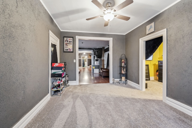 hall with carpet floors and ornamental molding