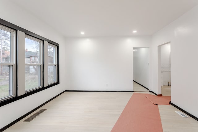 unfurnished room with basketball court and light hardwood / wood-style flooring