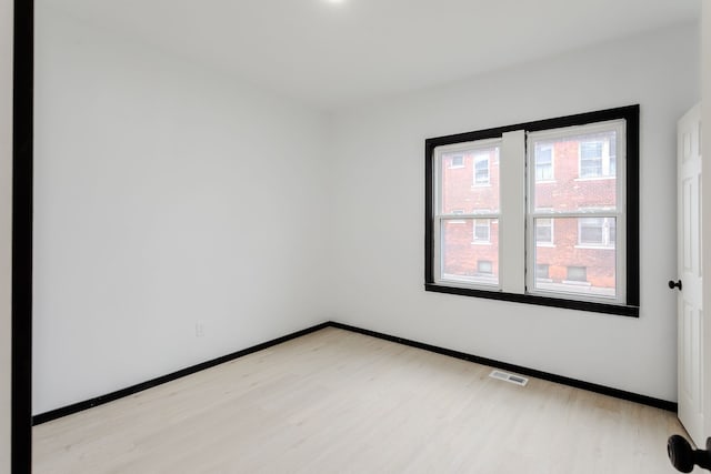 spare room with light hardwood / wood-style flooring