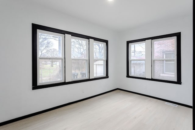 spare room featuring light hardwood / wood-style floors