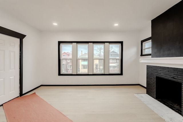 unfurnished living room with plenty of natural light and light hardwood / wood-style floors