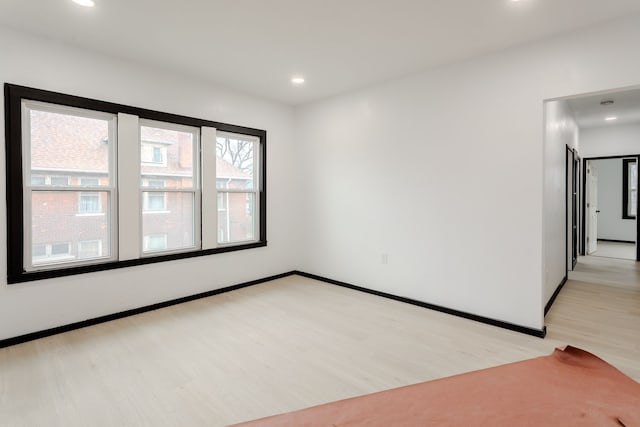 empty room with light hardwood / wood-style flooring