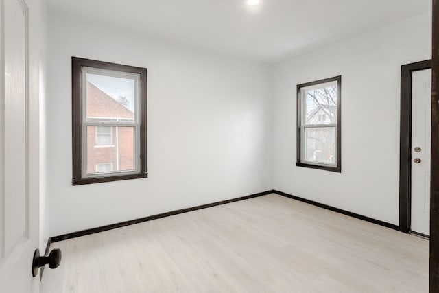 spare room featuring light hardwood / wood-style floors