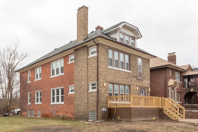 rear view of property with a wooden deck