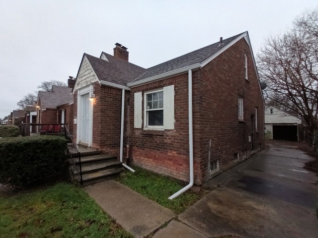 view of side of home with a garage and an outdoor structure