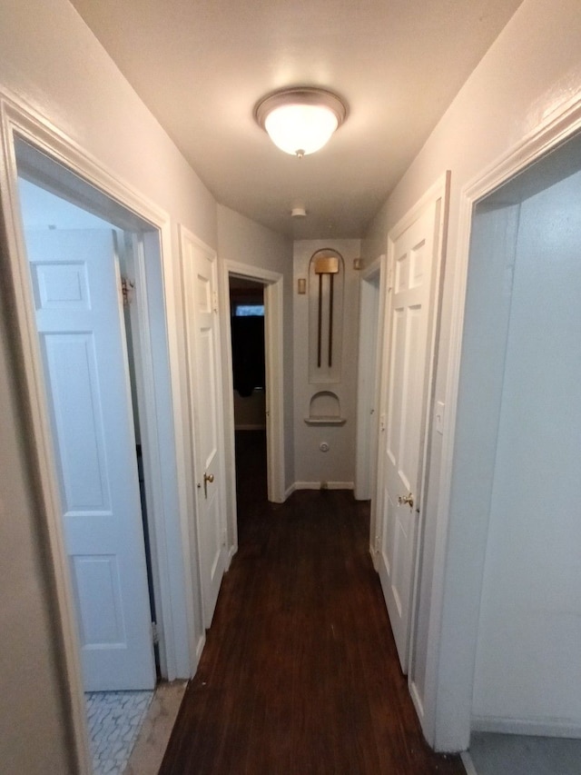 hall with dark hardwood / wood-style flooring