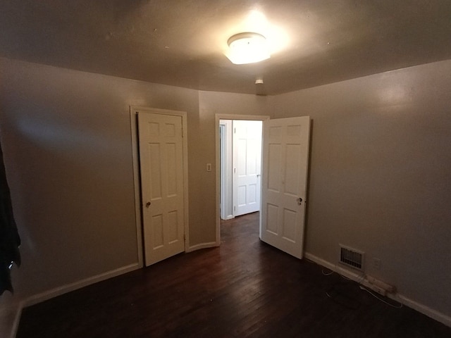 empty room with dark hardwood / wood-style floors