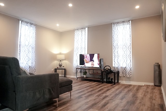 sitting room featuring a healthy amount of sunlight, hardwood / wood-style flooring, and crown molding